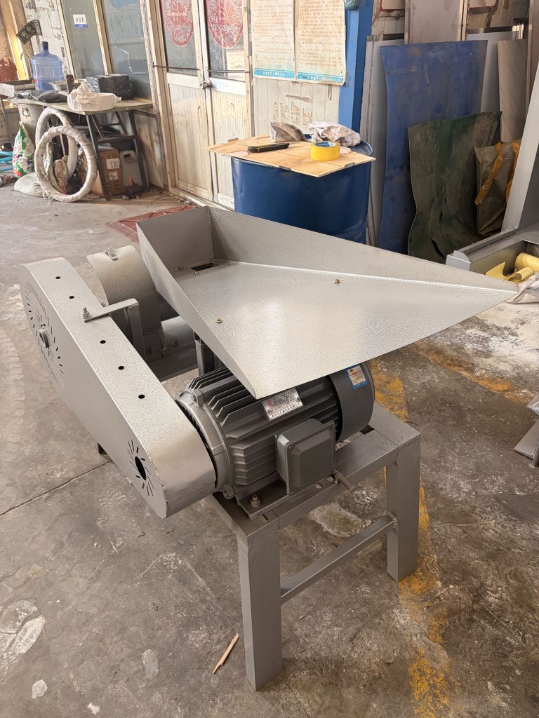 Oilseed crusher frame, hopper, and discharge arrangement