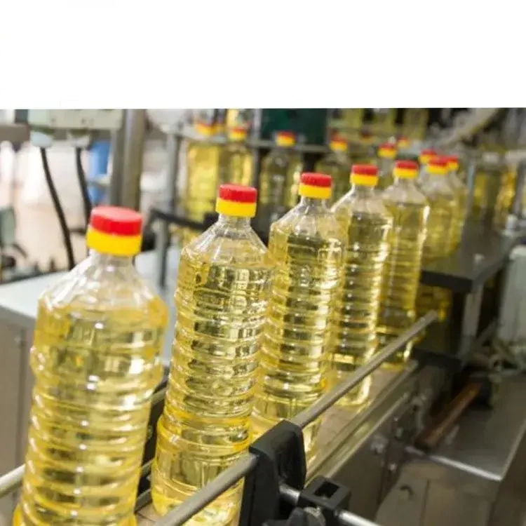 Filled edible oil bottles moving through a packaging line