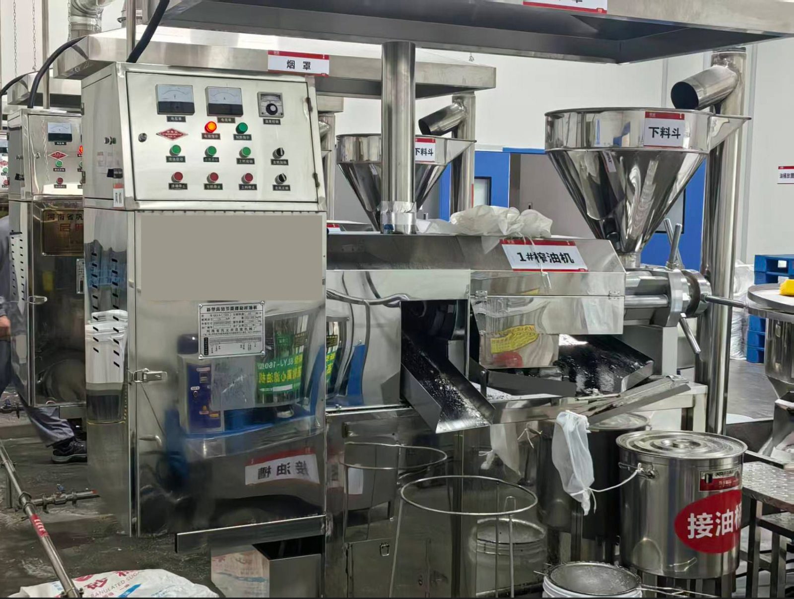 Continuous screw oil press machines operating in an oil workshop