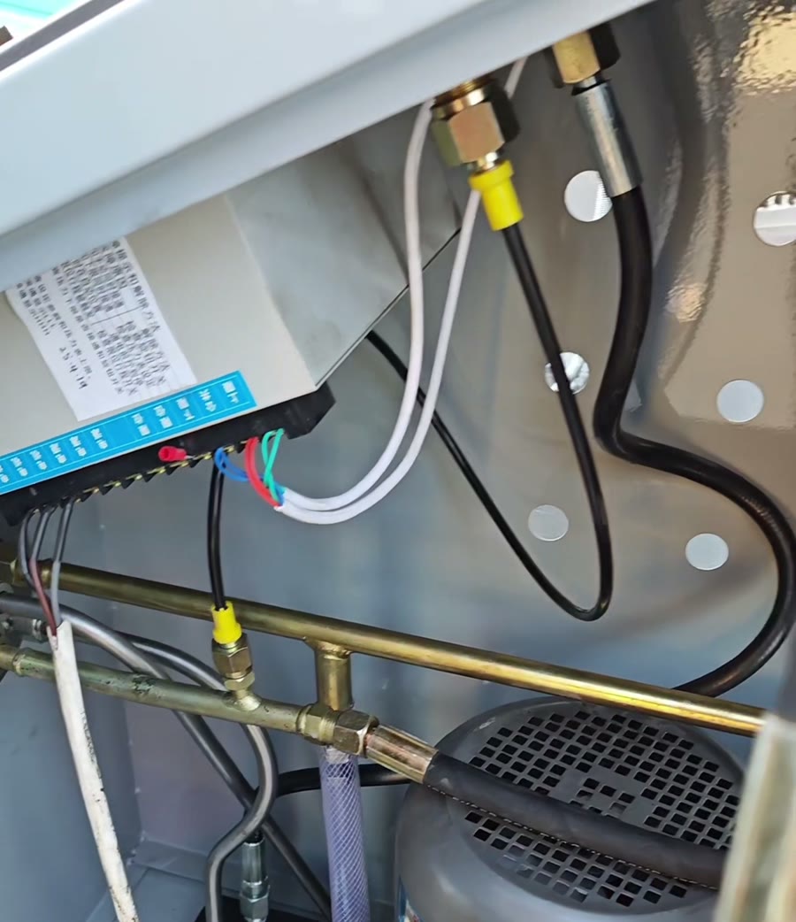 Connecting high-pressure hydraulic hoses inside the oil press power unit