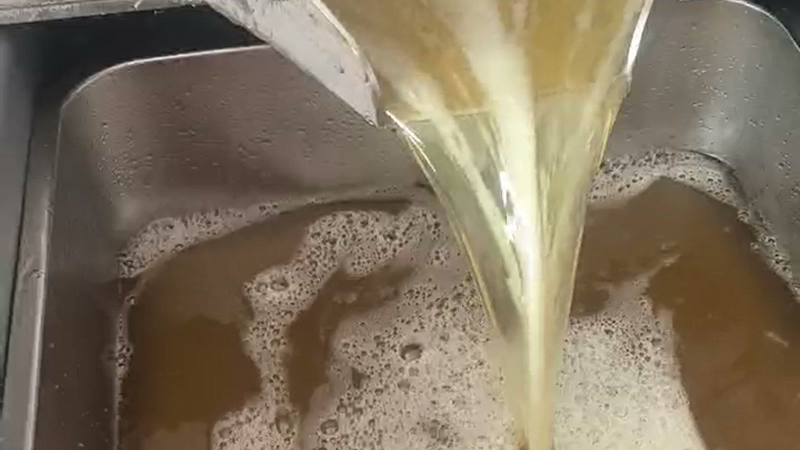 Fresh oil flowing from a hydraulic oil press